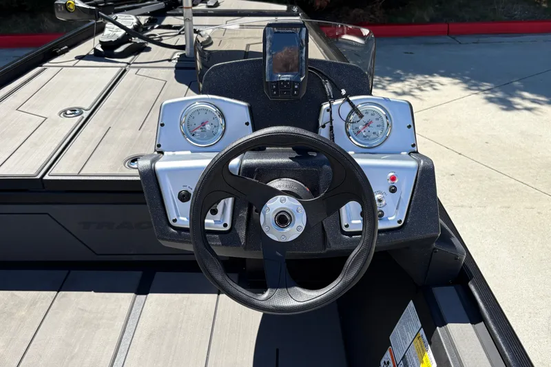 Slide: The Image of 2027 Tracker Pro 170 boat dashboard with steering wheel and gauges. - 24