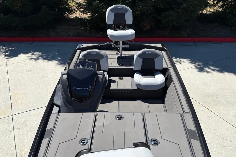 Slide: The Image of 2027 Tracker Pro 170 boat with seating and console, parked on concrete. - 14