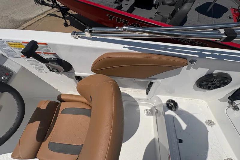 Slide: The Image of Interior of a 2027 Tahoe 2150 boat featuring tan seating and control panel. - 15