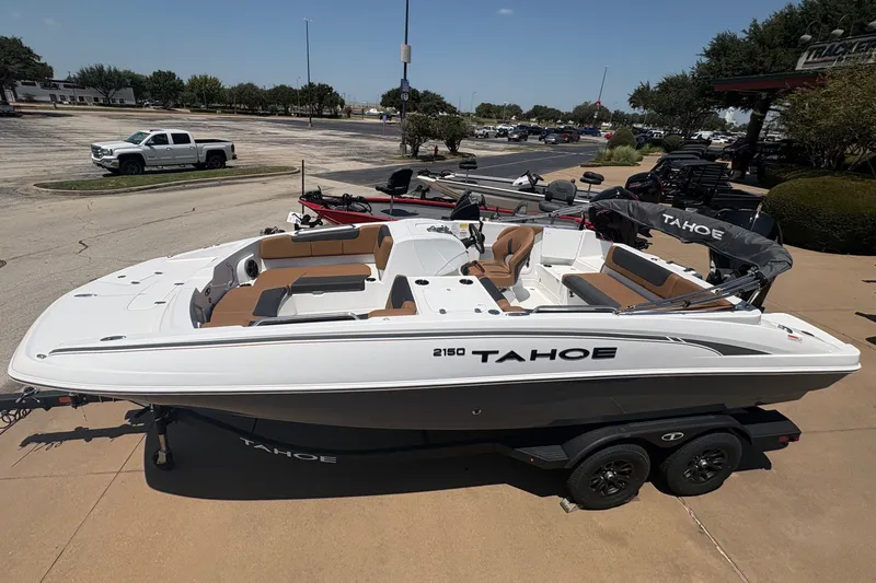 Slide: The Image of 2027 Tahoe 2150 boat on trailer in parking lot, sunny day. - 5