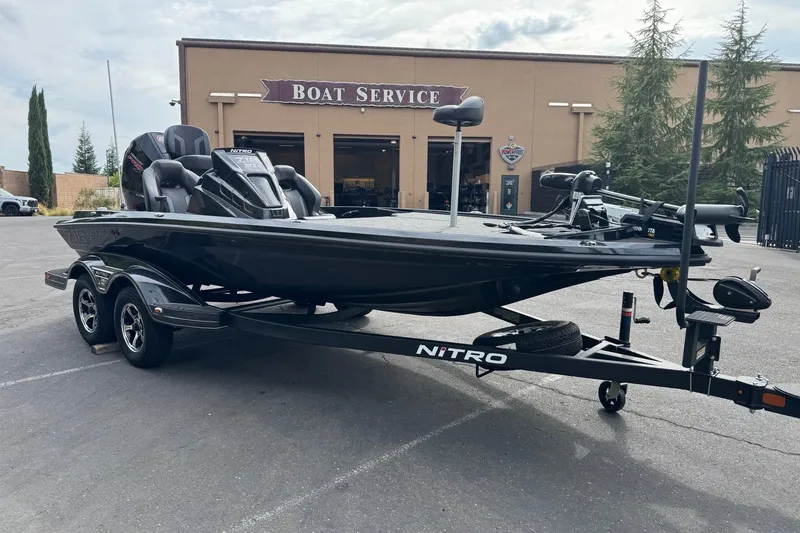Slide: The Image of 2027 Nitro Z18 XL Pro boat on trailer outside service center. - 3