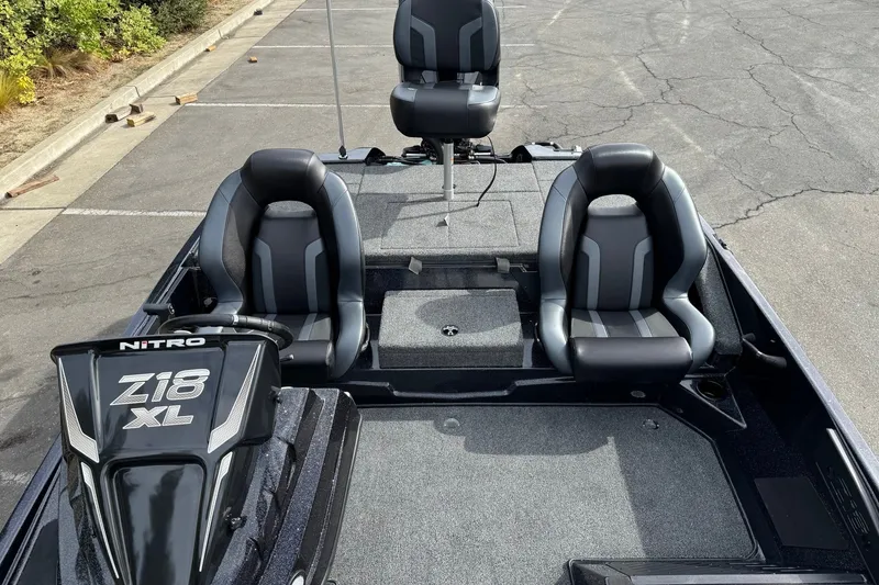 Slide: The Image of 2027 Nitro Z18 XL Pro boat interior with three black and gray seats. - 8