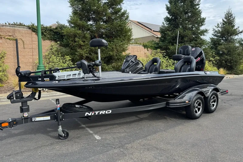Slide: The Image of 2027 Nitro Z18 XL Pro fishing boat on trailer, parked outdoors. - 2