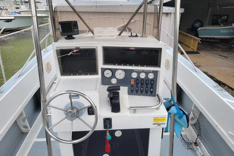 Slide: The Image of Grady-White Fisherman 204, 1990 model, boat dashboard with steering wheel and controls. - 3