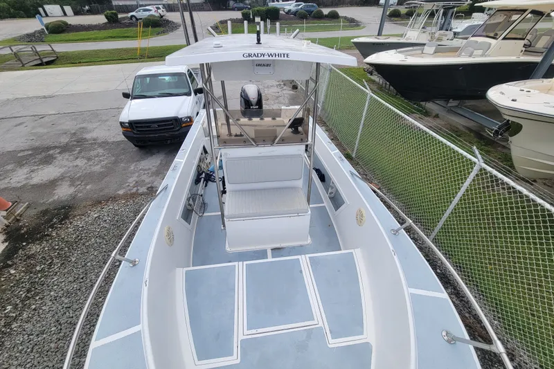 Slide: The Image of 1990 Grady-White Fisherman 204 boat with center console, parked near a fence. - 4