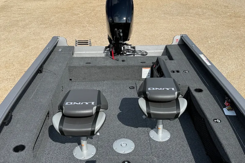 Slide: The Image of 2027 Lund 1875 Pro Guide boat interior with two seats and motor. - 8