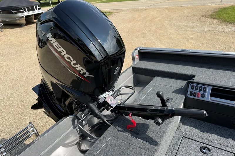 Slide: The Image of 2027 Lund 1875 Pro Guide boat with Mercury outboard motor, featuring control panel and seating area. - 16