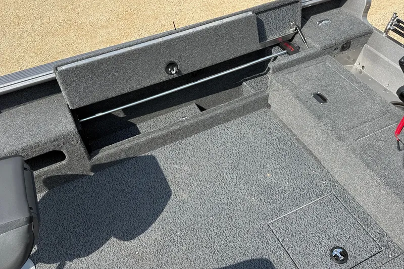 Slide: The Image of 2027 Lund 1875 Pro Guide boat interior with carpeted flooring and storage compartments. - 11