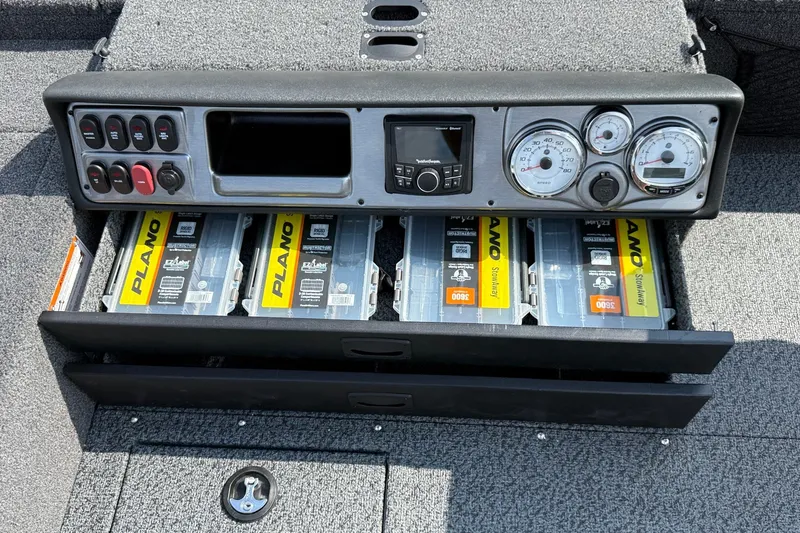 Slide: The Image of Control panel and storage of 2027 Lund 1875 Pro Guide boat with Plano tackle boxes. - 14