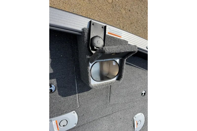 Slide: The Image of 2027 Lund 1875 Pro Guide boat interior with cup holder and carpeted flooring. - 6