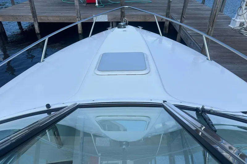 Slide: The Image of 2004 Formula 280 Sun Sport boat docked at a wooden pier. - 14