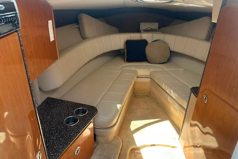 Slide: The Image of Interior of 2004 Formula 280 Sun Sport boat with cushioned seating and wooden cabinetry. - 23