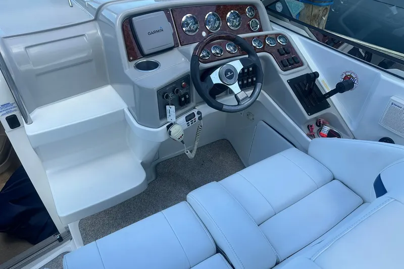 Slide: The Image of 2004 Formula 280 Sun Sport boat cockpit with steering wheel and control panel. - 12