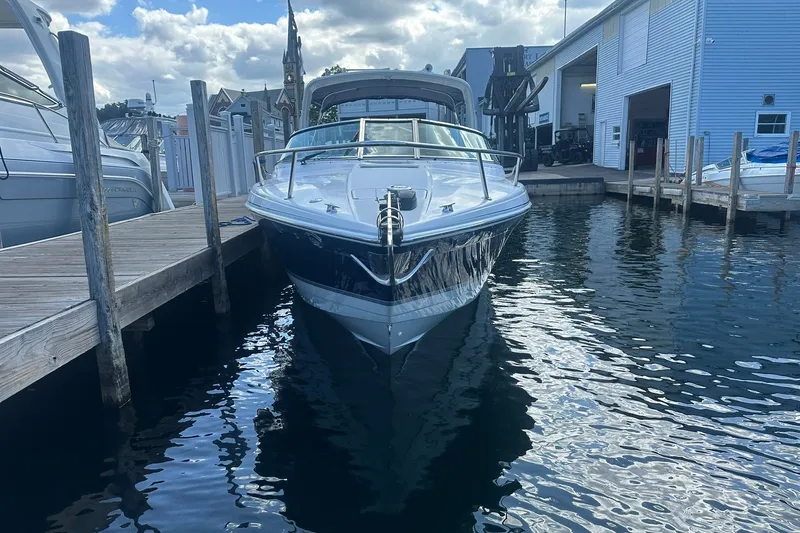Slide: The Image of 2004 Formula 280 Sun Sport docked at marina, reflecting on calm water. - 3