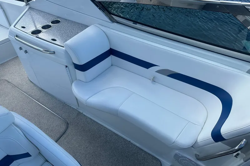 Slide: The Image of 2004 Formula 280 Sun Sport boat interior with white seating and cup holders. - 17