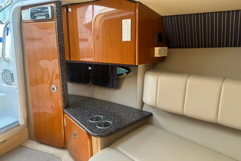 Slide: The Image of Interior of 2004 Formula 280 Sun Sport boat with wood cabinetry and cushioned seating. - 26