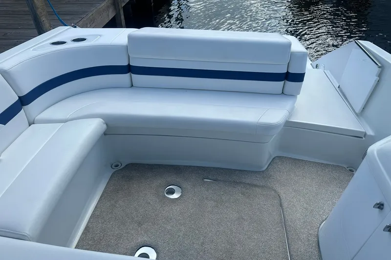 Slide: The Image of 2004 Formula 280 Sun Sport boat interior with white seating and blue accents. - 19