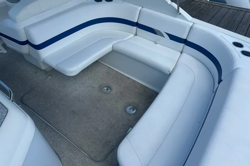 Slide: The Image of 2004 Formula 280 Sun Sport boat interior with white seating and blue accents. - 10