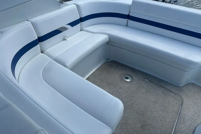 Slide: The Image of 2004 Formula 280 Sun Sport boat interior with white and blue seating, carpeted floor. - 18