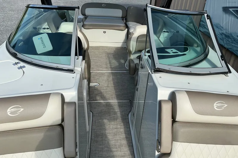 Slide: The Image of 2020 Crownline 290 SS boat interior with beige seating and dual windshields. - 11