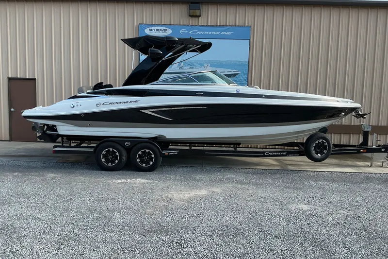 The Image of 2020 Crownline 290 SS boat on trailer, parked outside a building. - 0