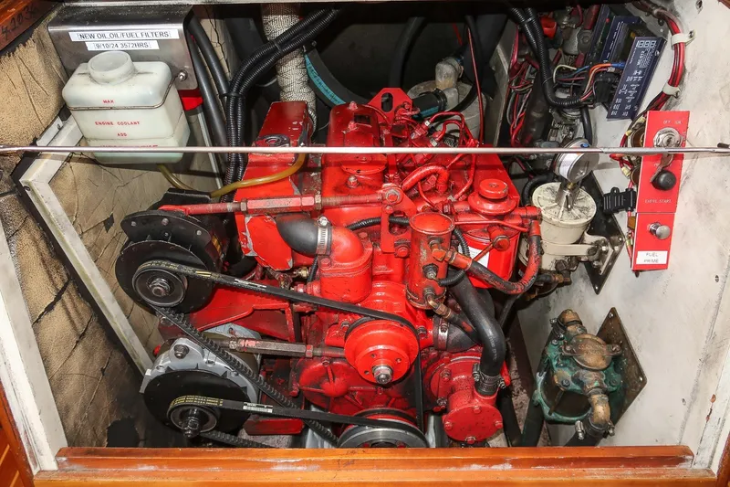 Slide: The Image of Engine compartment of a 1987 Hinckley Sou'wester 42 sailboat, showcasing a red marine engine. - 43