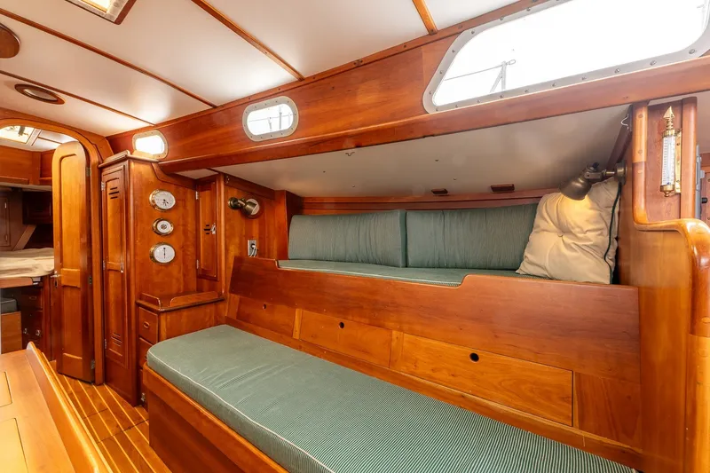 Slide: The Image of Interior of 1987 Hinckley Sou'wester 42 sailboat with wooden finish and green cushions. - 33