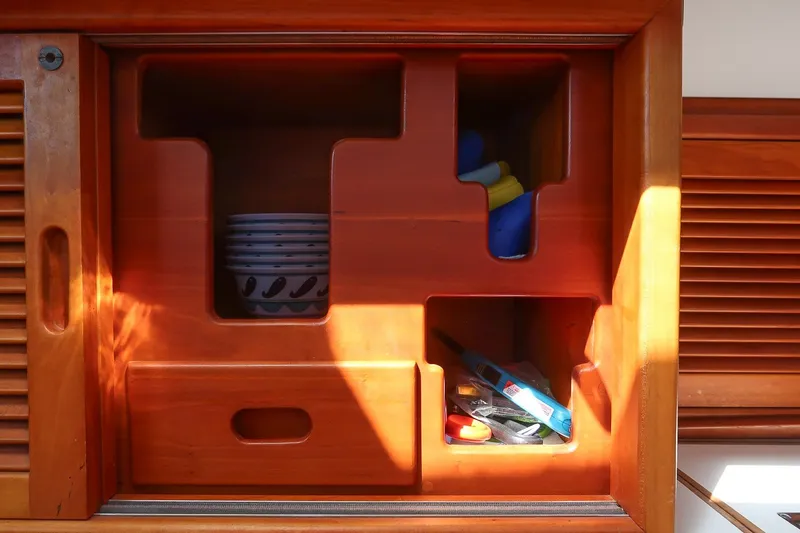 Slide: The Image of Wooden cabinet interior on 1987 Hinckley Sou'wester 42 yacht, featuring organized storage compartments. - 42