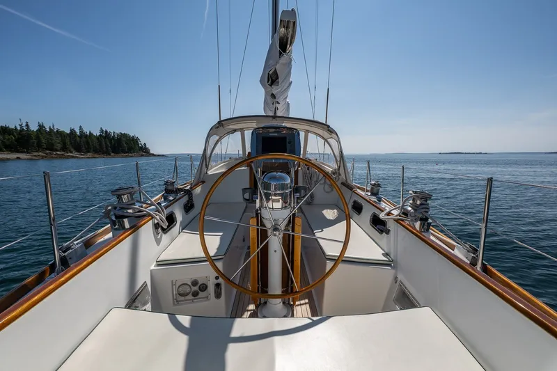 Slide: The Image of Hinckley Sou'wester 42 sailboat cockpit, 1987 model, on calm waters with clear skies. - 19