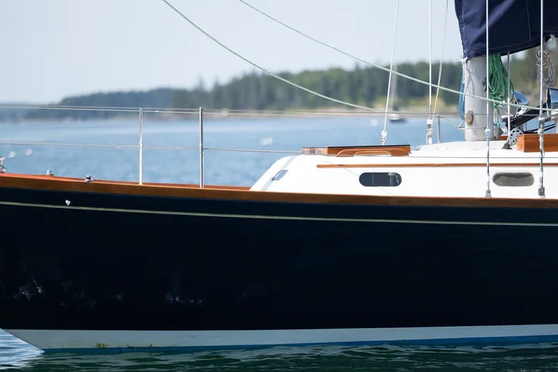 Slide: The Image of 1987 Hinckley Sou'wester 42 sailboat on calm water, showcasing elegant design and craftsmanship. - 46