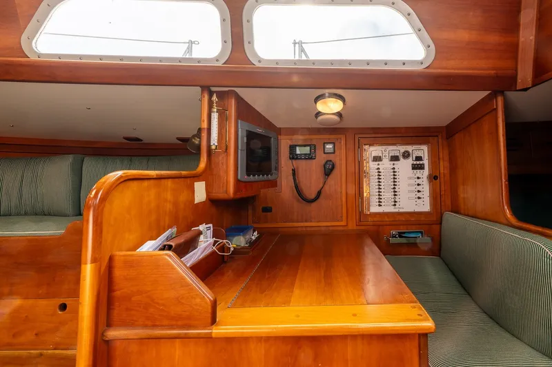 Slide: The Image of Interior of 1987 Hinckley Sou'wester 42 sailboat with wooden navigation station and seating area. - 30
