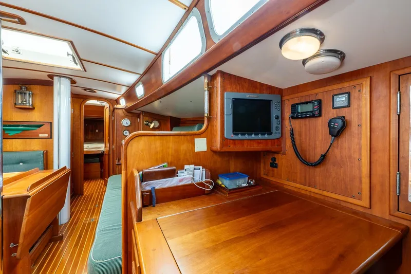 Slide: The Image of Interior of 1987 Hinckley Sou'wester 42 sailboat with navigation equipment and wooden furnishings. - 31
