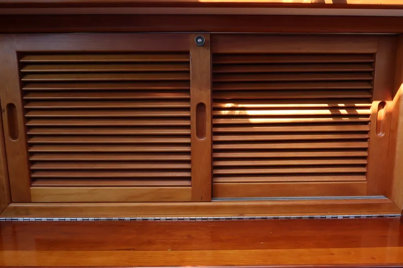 Slide: The Image of Wooden louvered cabinet doors on a 1987 Hinckley Sou'wester 42 yacht interior. - 40