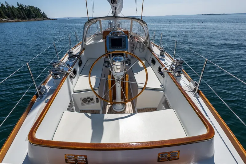 Slide: The Image of 1987 Hinckley Sou'wester 42 sailboat cockpit with wooden wheel, on calm sea. - 18