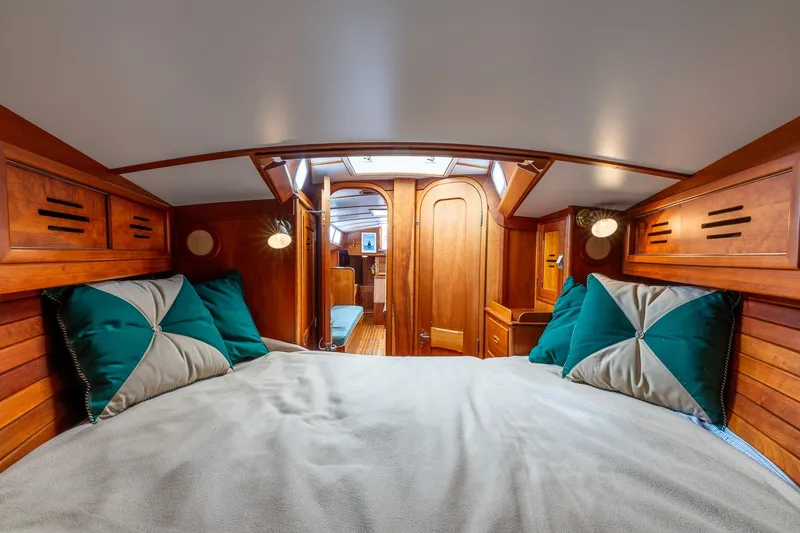 Slide: The Image of Cozy cabin interior of 1987 Hinckley Sou'wester 42 sailboat with wooden finish and plush bedding. - 37