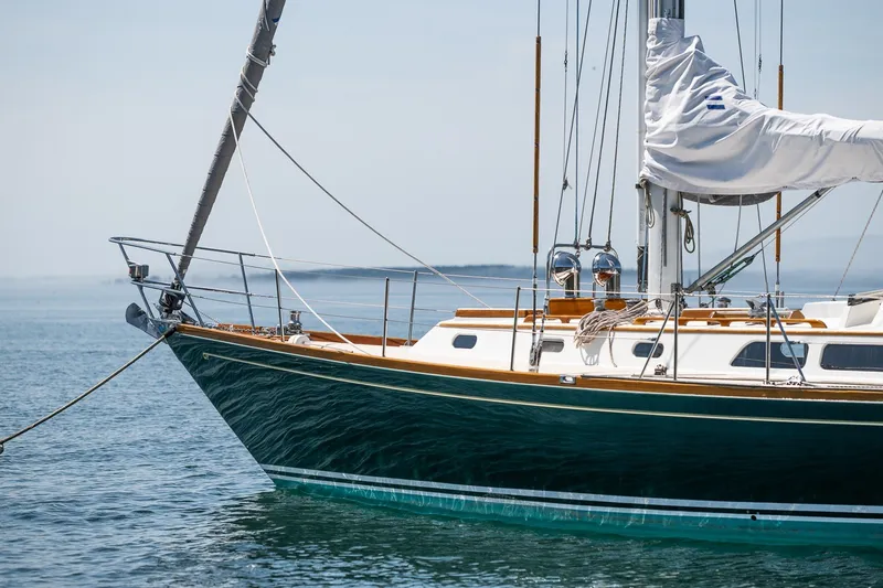 Slide: The Image of 1987 Hinckley Sou'wester 42 sailboat on calm water, showcasing elegant design. - 6