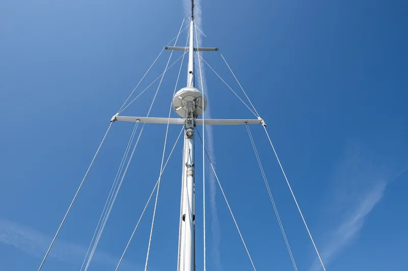 Slide: The Image of Mast of 1987 Hinckley Sou'wester 42 sailboat against clear blue sky. - 13