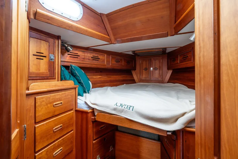 Slide: The Image of Cozy wooden cabin interior of 1987 Hinckley Sou'wester 42 sailboat with bed and storage. - 36