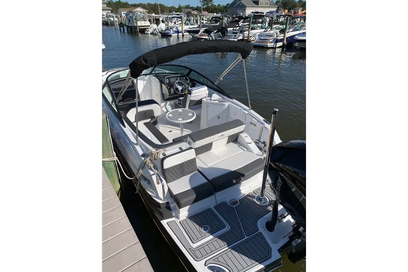 Slide: The Image of 2021 Monterey M-45 boat docked, featuring sleek seating and modern design. - 2