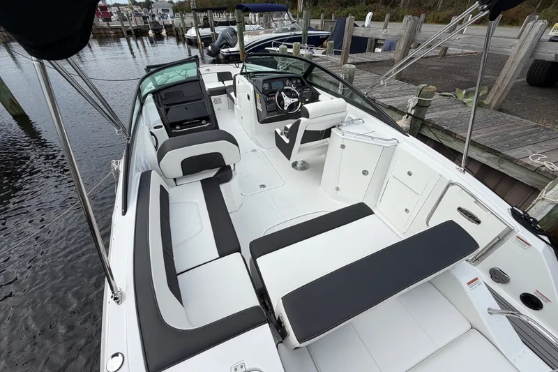 Slide: The Image of 2021 Monterey M-45 boat interior with sleek seating and modern dashboard at a dock. - 15