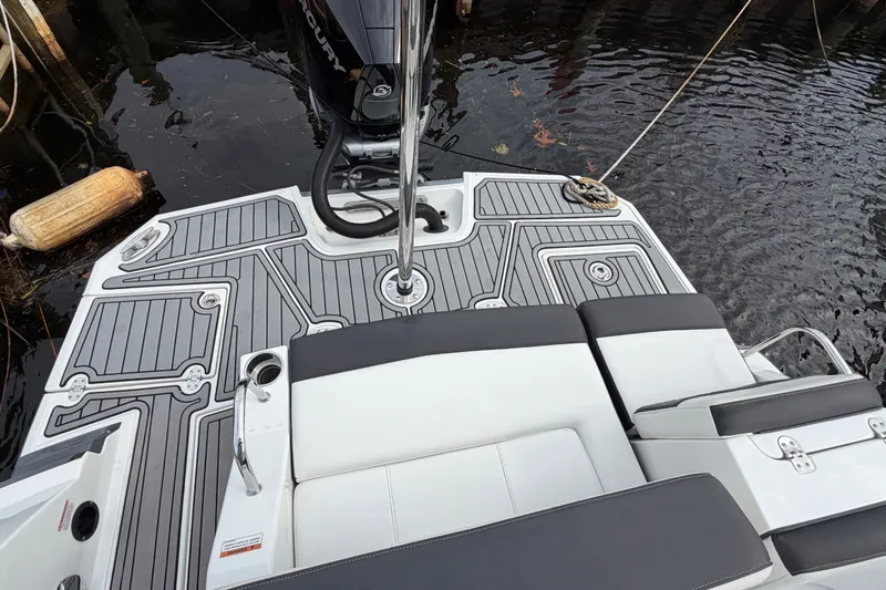 Slide: The Image of 2021 Monterey M-45 boat deck with seating and motor, docked on calm water. - 13