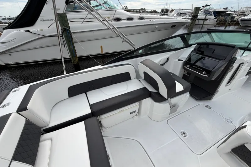 Slide: The Image of 2021 Monterey M-45 boat interior with sleek seating and modern dashboard at marina. - 22