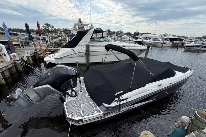 Slide: The Image of 2021 Monterey M-45 boat docked at a marina, covered and ready for use. - 47