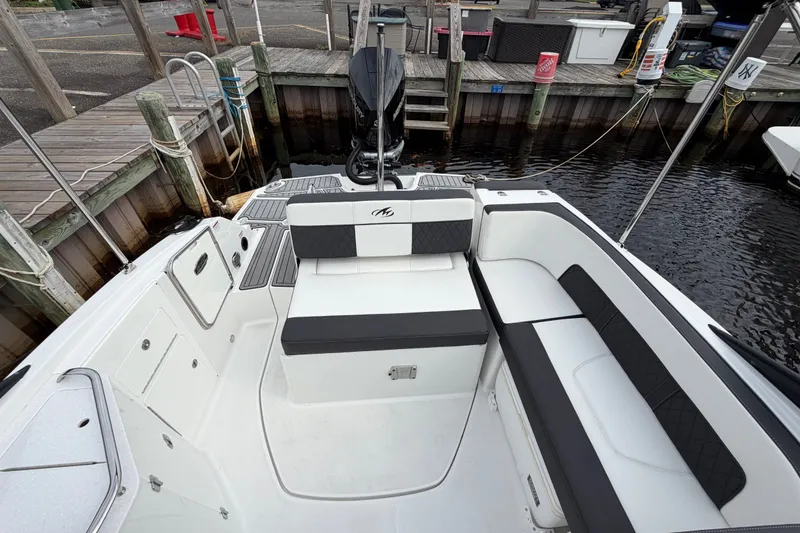 Slide: The Image of 2021 Monterey M-45 boat interior with sleek seating and modern design at a dock. - 19