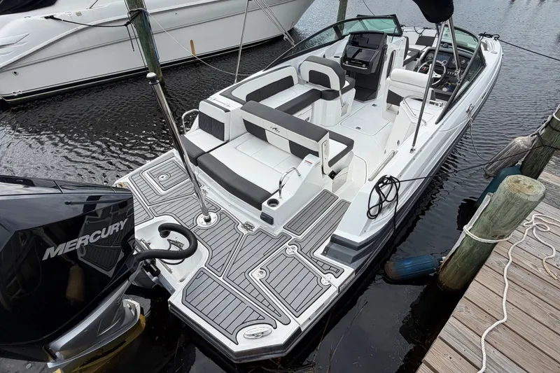 Slide: The Image of 2021 Monterey M-45 boat docked, featuring spacious seating and Mercury outboard engine. - 10