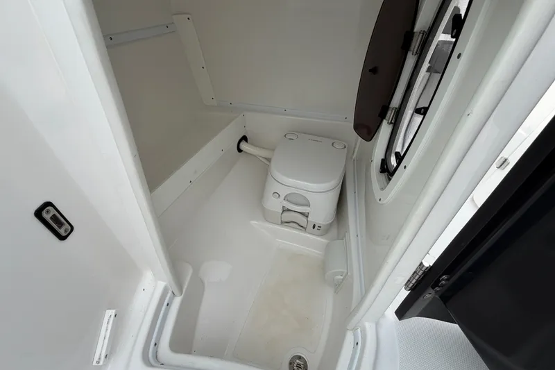 Slide: The Image of 2021 Monterey M-45 boat interior with compact marine toilet and window. - 32