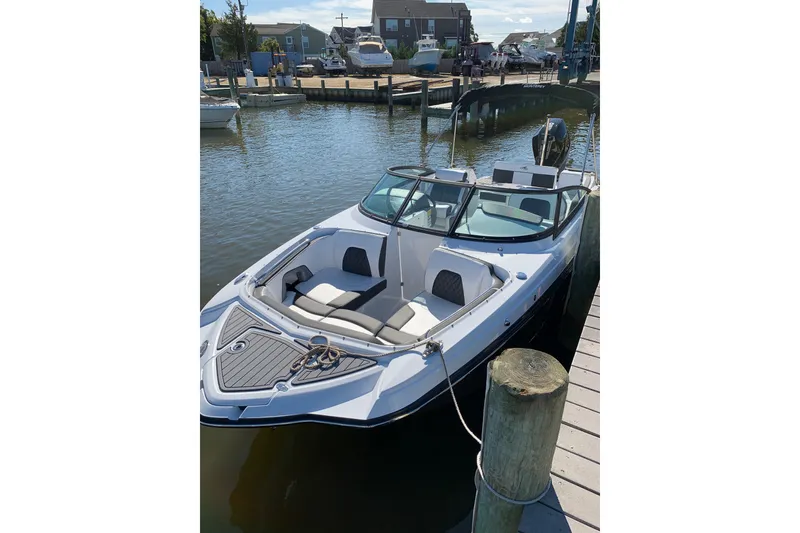 Slide: The Image of 2021 Monterey M-45 boat docked at a marina, featuring sleek design and spacious seating. - 1
