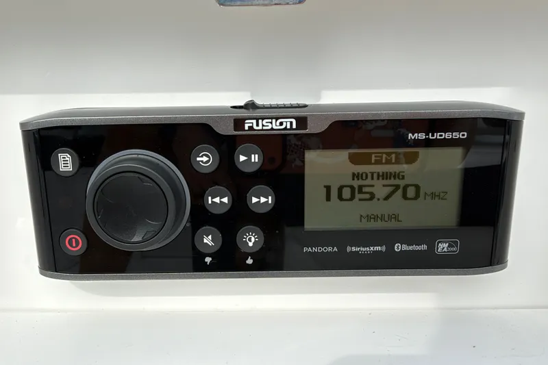 Slide: The Image of Boat stereo system, Fusion MS-UD650, displaying FM 105.70 MHz, in a 2021 Monterey M-45. - 39