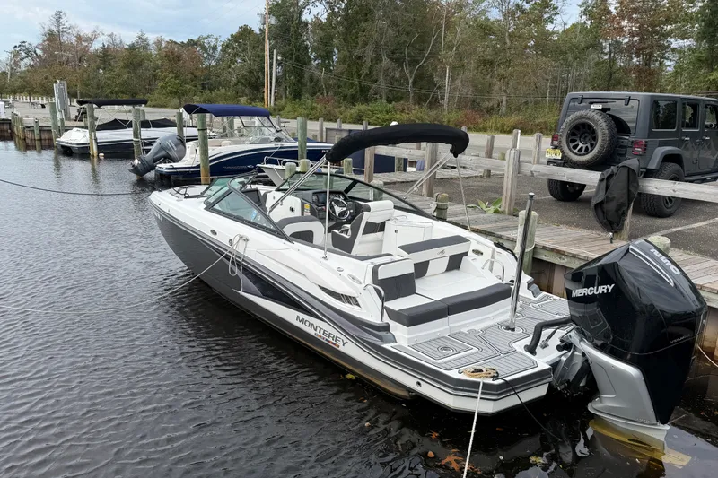 Slide: The Image of 2021 Monterey M-45 boat docked with Mercury outboard motor, surrounded by other boats. - 12