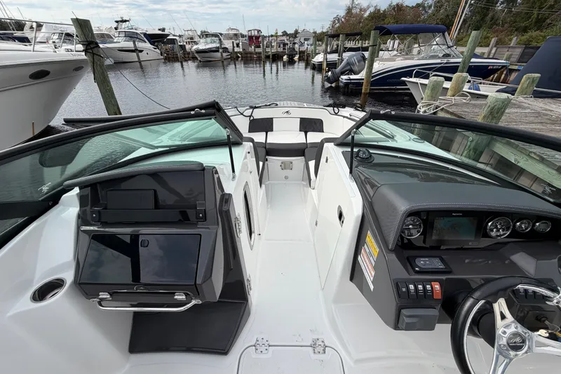 Slide: The Image of 2021 Monterey M-45 boat interior at marina, featuring sleek dashboard and seating. - 29